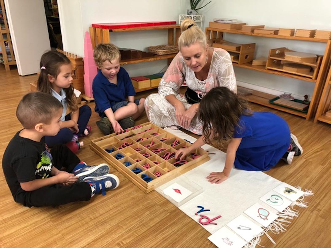 Primary teacher working on spelling with students